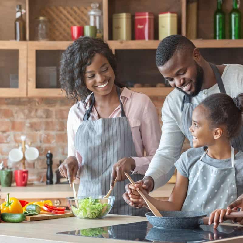 young parents teaching daughter how to cook QTLZGW8 800x800 - 7 Cool Things To Do With Your Kids At Home